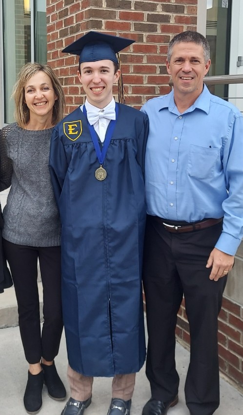 Ryan with parents in graduation regalia